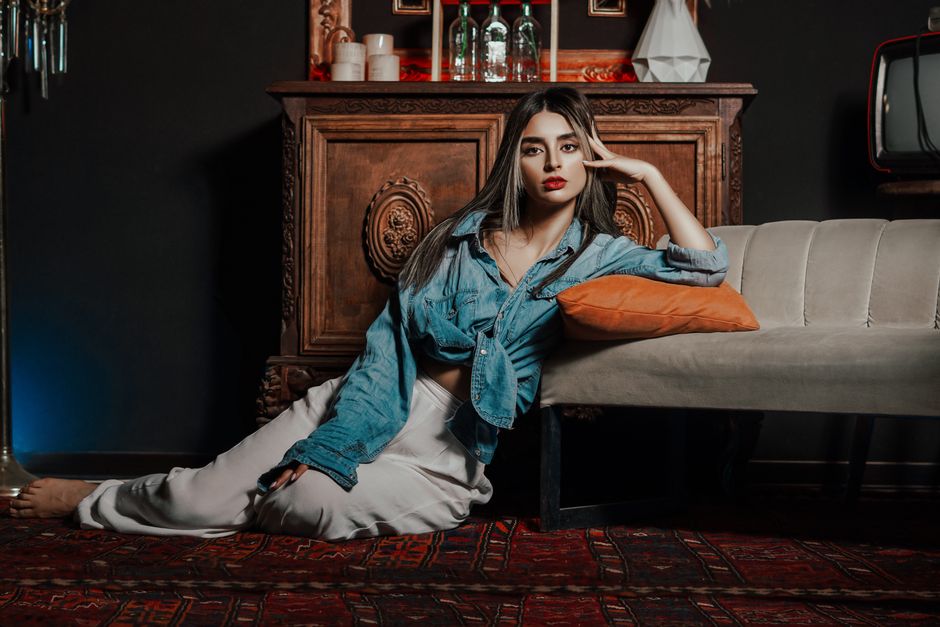 Chic woman lounging in an elegant Tehran interior setting, showcasing modern style.